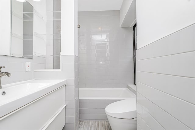 237 Eldridge St Unit 3 & 4, New York Manhattan, NY 10002 - full bathroom with tile walls, vanity, and bathtub / shower combination