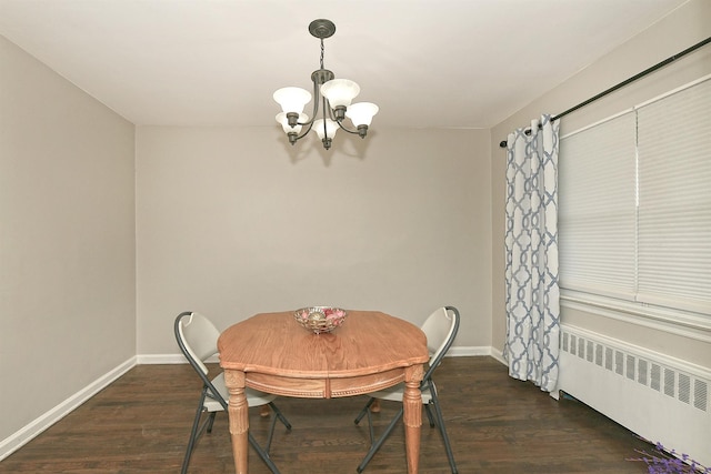 169-04 69th Ave, Fresh Meadows, NY 11365 - dining area featuring radiator heating unit, a chandelier, and wood finished floors