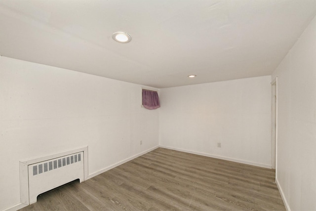169-04 69th Ave, Fresh Meadows, NY 11365 - additional living space with radiator heating unit, wood finished floors, and recessed lighting