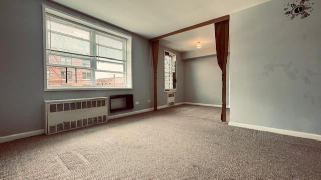 143-43 41 Unit 5C, Flushing, NY 11355 - carpeted spare room featuring radiator heating unit and healthy amount of natural light
