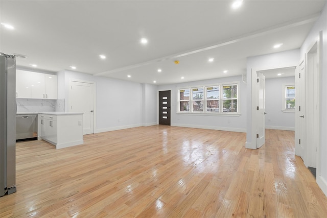 22019 135th Ave, Addisleigh Park, NY 11413 - unfurnished living room featuring light wood-type flooring and recessed lighting