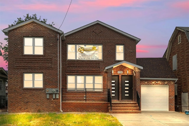 22019 135th Ave, Addisleigh Park, NY 11413 - view of front of property featuring brick siding, a garage, and driveway