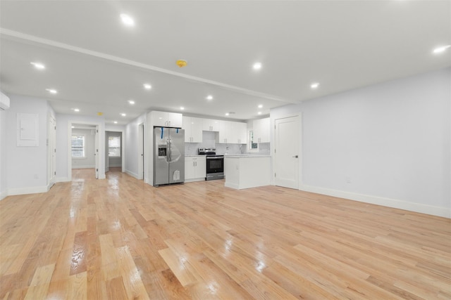 22019 135th Ave, Addisleigh Park, NY 11413 - unfurnished living room featuring light wood-style flooring and recessed lighting