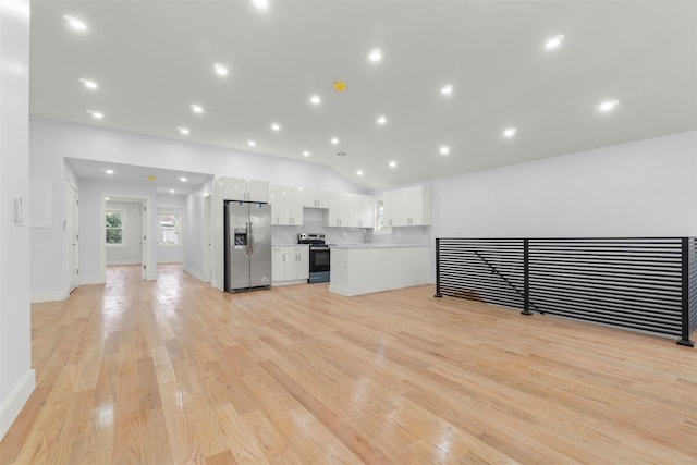 22019 135th Ave, Addisleigh Park, NY 11413 - unfurnished living room with light wood finished floors, vaulted ceiling, and recessed lighting