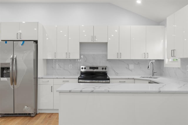 22019 135th Ave, Addisleigh Park, NY 11413 - kitchen featuring appliances with stainless steel finishes, white cabinets, modern cabinets, and vaulted ceiling