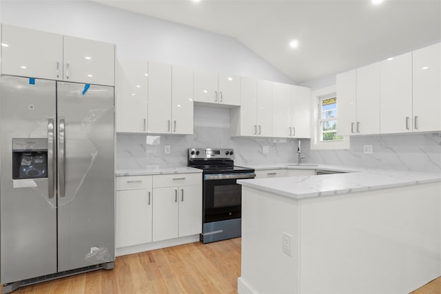 22019 135th Ave, Addisleigh Park, NY 11413 - kitchen with stainless steel appliances, light wood-style flooring, white cabinets, lofted ceiling, and backsplash