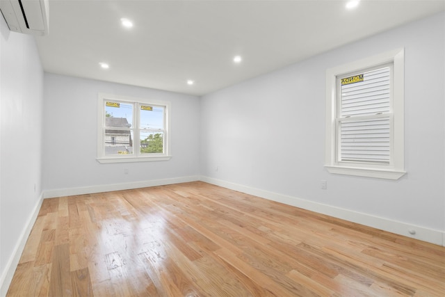 22019 135th Ave, Addisleigh Park, NY 11413 - spare room featuring a wall mounted air conditioner, light wood-style floors, and recessed lighting