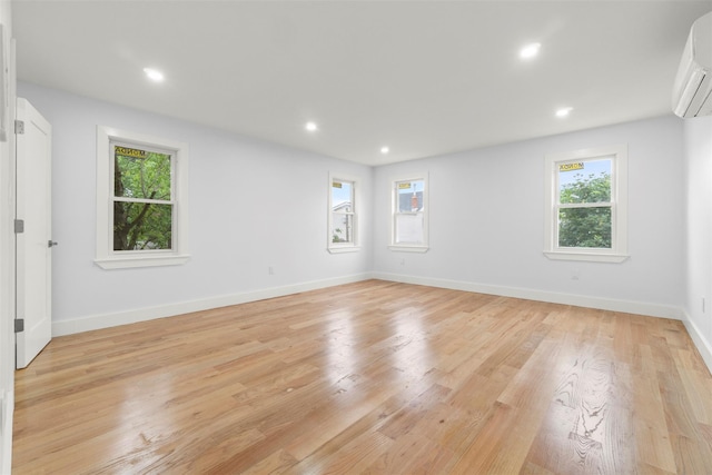 22019 135th Ave, Addisleigh Park, NY 11413 - spare room with a wall mounted air conditioner, recessed lighting, and light wood finished floors