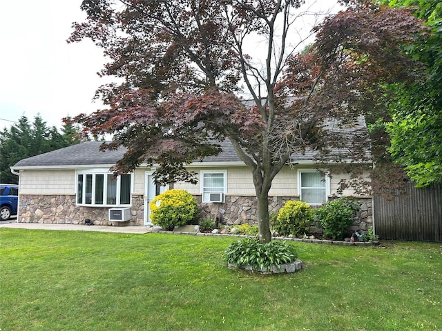 166 W 2nd St, West Islip, NY 11795 - view of property hidden behind natural elements with stone siding, a front lawn, and cooling unit