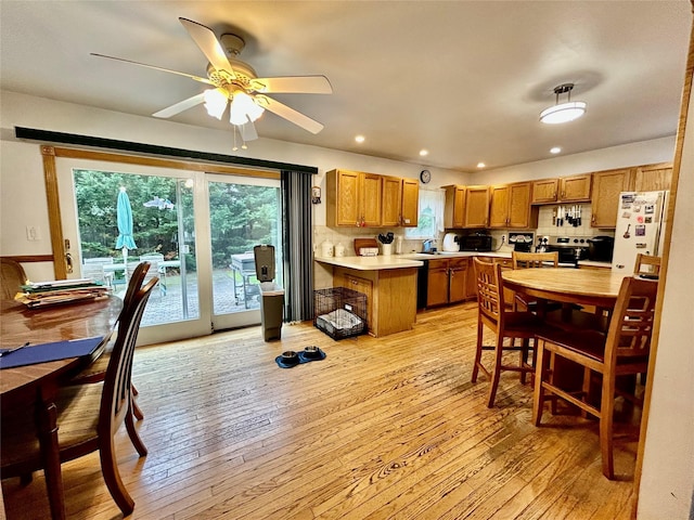 166 W 2nd St, West Islip, NY 11795 - kitchen with freestanding refrigerator, light countertops, brown cabinetry, light wood finished floors, and recessed lighting