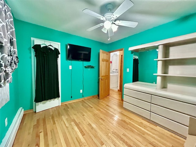 166 W 2nd St, West Islip, NY 11795 - unfurnished bedroom featuring baseboard heating, hardwood / wood-style floors, ceiling fan, and washer / clothes dryer