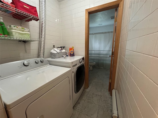 166 W 2nd St, West Islip, NY 11795 - laundry room with separate washer and dryer, tile walls, and a baseboard heating unit