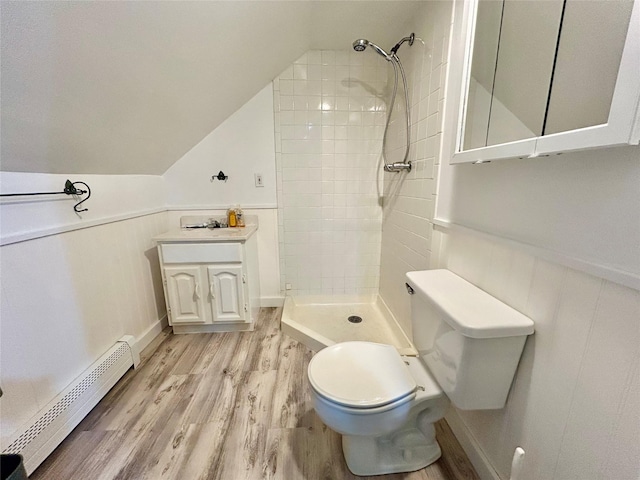 166 W 2nd St, West Islip, NY 11795 - full bathroom with a baseboard radiator, wood finished floors, a tile shower, lofted ceiling, and wainscoting