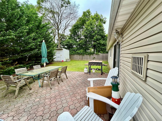 166 W 2nd St, West Islip, NY 11795 - fenced backyard featuring outdoor dining area, a storage unit, a patio area, and a grill