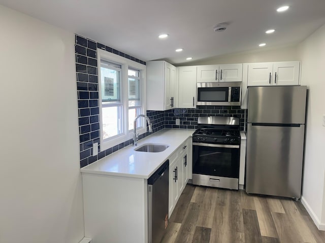 6 Hillcrest Trl, Monroe, NY 10950 - kitchen featuring appliances with stainless steel finishes, dark wood-style floors, light countertops, tasteful backsplash, and white cabinetry