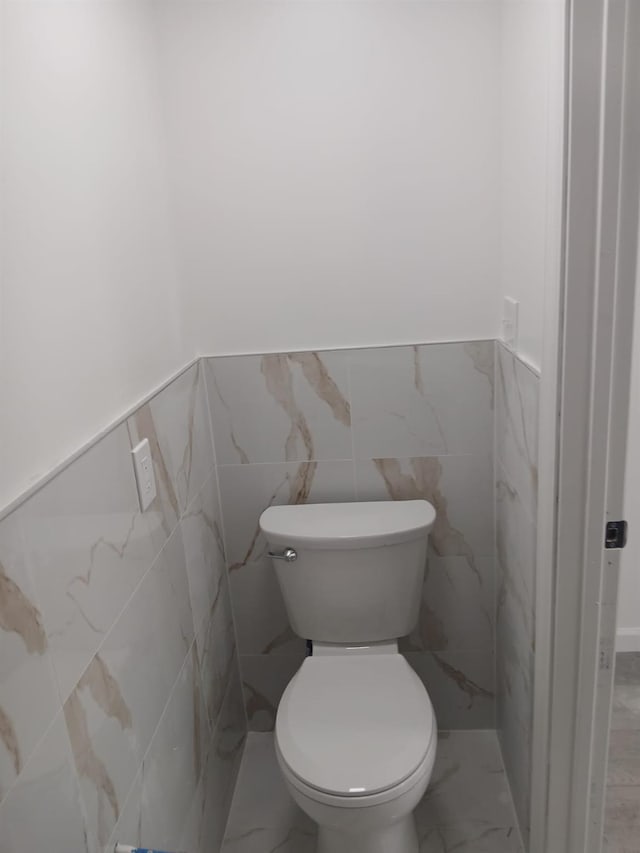 6 Hillcrest Trl, Monroe, NY 10950 - bathroom with marble look tile flooring, a wainscoted wall, and tile walls