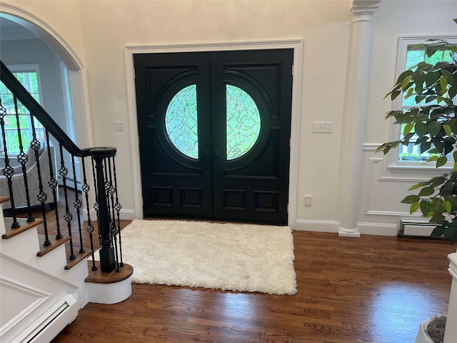 5 Odell Dr, Stony Point, NY 10980 - entrance foyer with a baseboard radiator, arched walkways, stairway, and wood finished floors