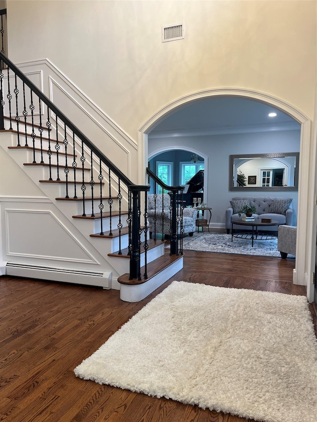 5 Odell Dr, Stony Point, NY 10980 - stairway with arched walkways, baseboard heating, a high ceiling, and wood finished floors