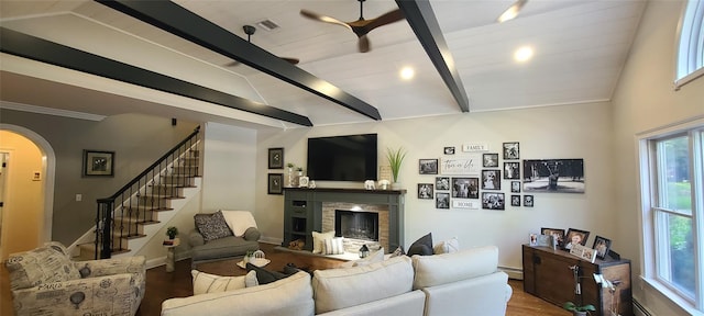 5 Odell Dr, Stony Point, NY 10980 - living room featuring wood finished floors, a fireplace, arched walkways, and plenty of natural light