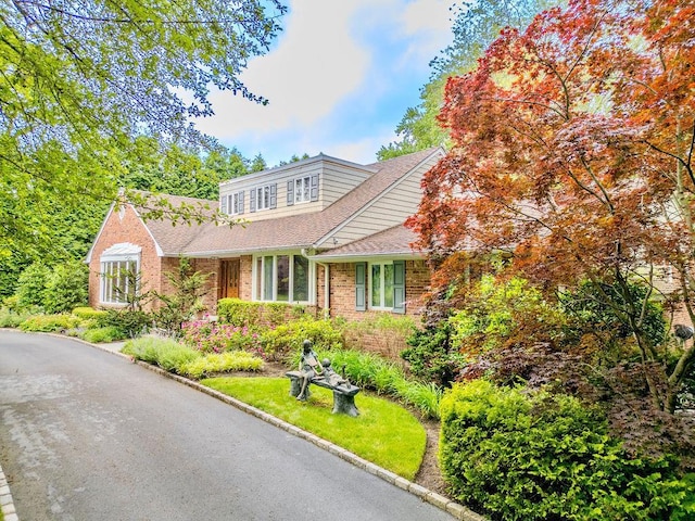 14 Pine Dr, Woodbury, NY 11797 - view of front of house with a shingled roof and brick siding