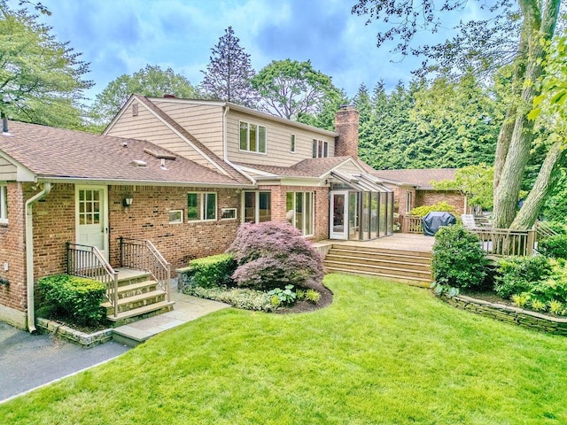 14 Pine Dr, Woodbury, NY 11797 - back of property with brick siding, a chimney, a yard, roof with shingles, and a wooden deck