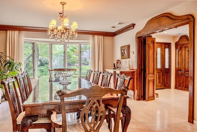 14 Pine Dr, Woodbury, NY 11797 - dining area with a chandelier, light tile patterned flooring, and ornamental molding
