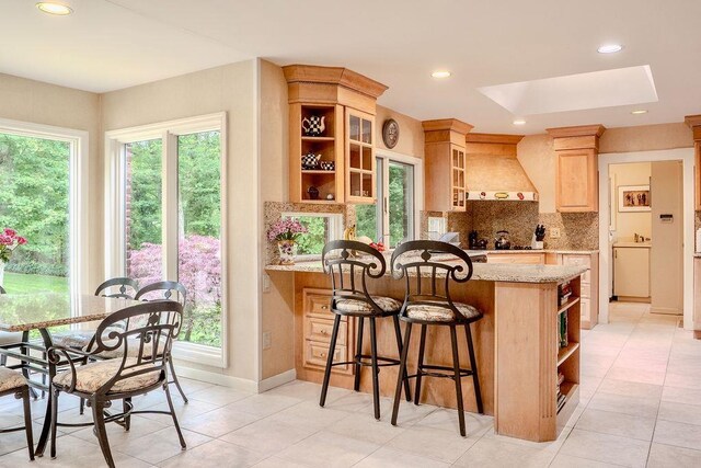 14 Pine Dr, Woodbury, NY 11797 - kitchen with open shelves, custom range hood, decorative backsplash, a peninsula, and light stone countertops