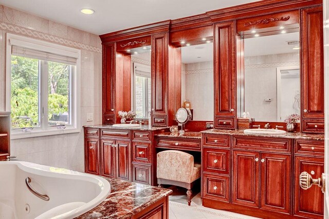 14 Pine Dr, Woodbury, NY 11797 - bathroom featuring tile walls, vanity, a jetted tub, and tile patterned flooring