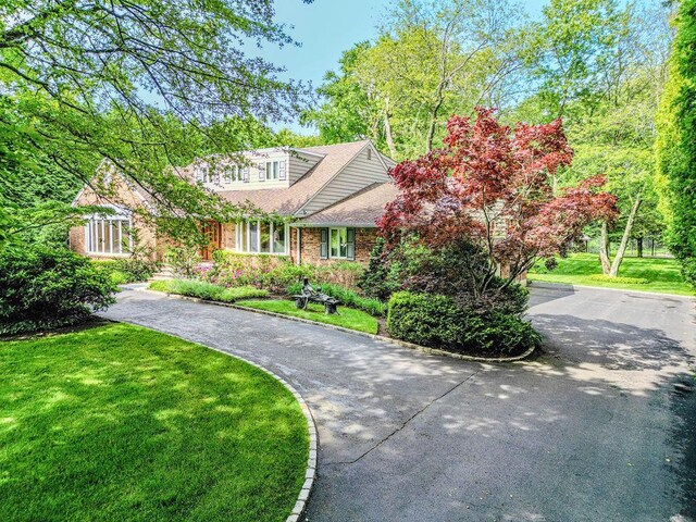 14 Pine Dr, Woodbury, NY 11797 - view of front of house with a front lawn and brick siding