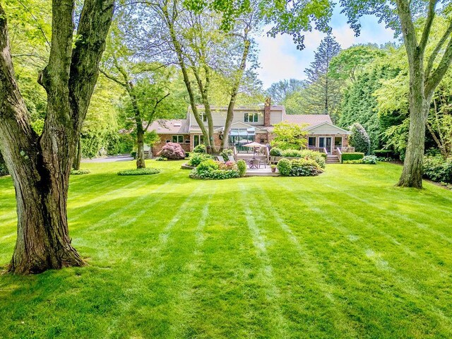 14 Pine Dr, Woodbury, NY 11797 - view of grassy yard with a deck
