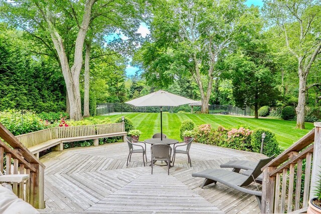 14 Pine Dr, Woodbury, NY 11797 - wooden deck featuring a fenced backyard, outdoor dining space, and view of wooded area