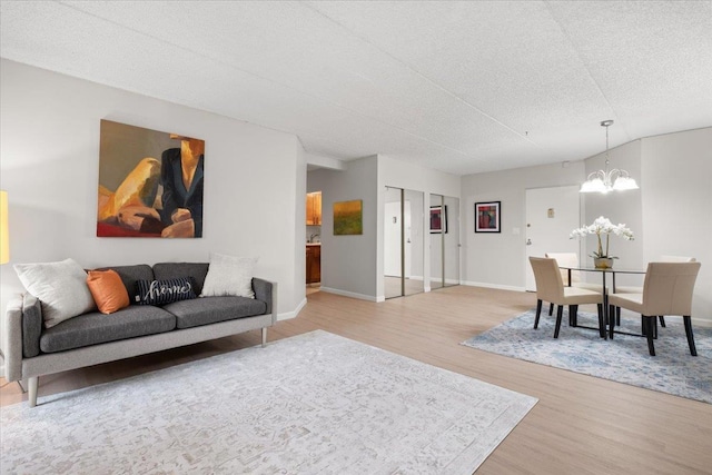 66 Crisfield St Unit 2B, Yonkers, NY 10710 - living area with light wood-style floors, a chandelier, and a textured ceiling