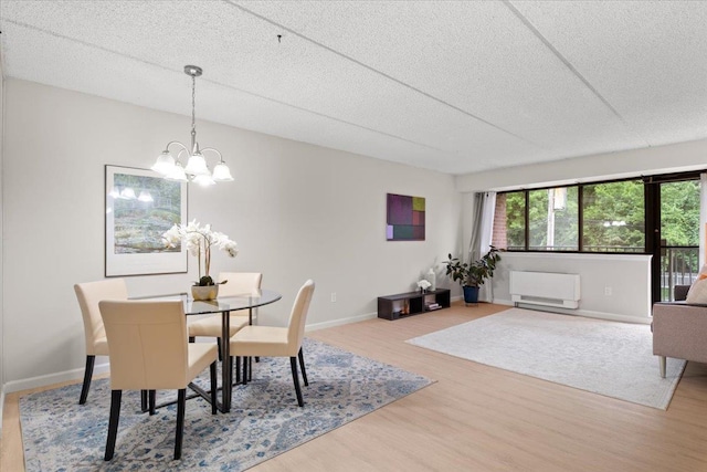 66 Crisfield St Unit 2B, Yonkers, NY 10710 - dining area with wood finished floors, a chandelier, and a textured ceiling