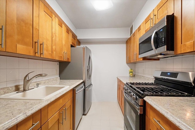 66 Crisfield St Unit 2B, Yonkers, NY 10710 - kitchen with stainless steel appliances, brown cabinets, light countertops, and tasteful backsplash