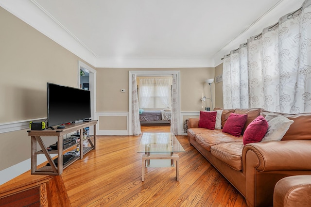 42 S Montague St, Valley Stream, NY 11580 - living area with light wood-style floors, a wainscoted wall, and crown molding