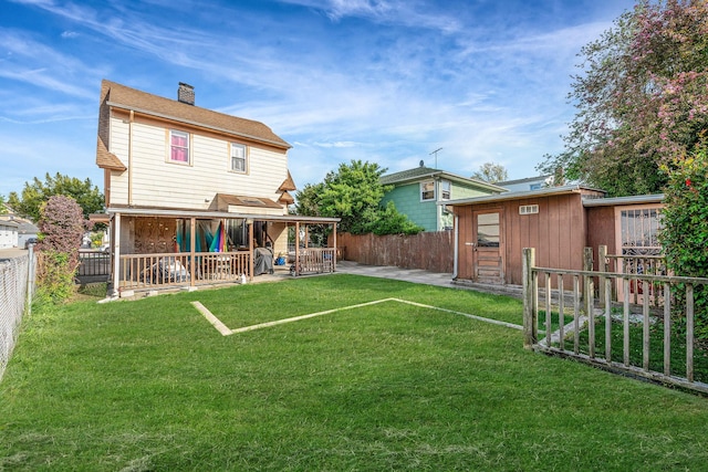 42 S Montague St, Valley Stream, NY 11580 - back of property with a fenced backyard, a chimney, a patio, and a storage unit