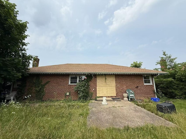 788 Dean Dr, Baldwin, NY 11510 - rear view of property with a chimney and brick siding