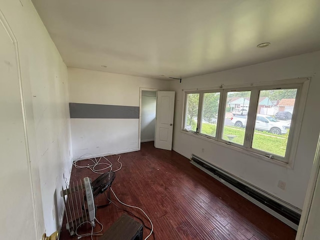 788 Dean Dr, Baldwin, NY 11510 - unfurnished room featuring dark wood finished floors and a baseboard heating unit