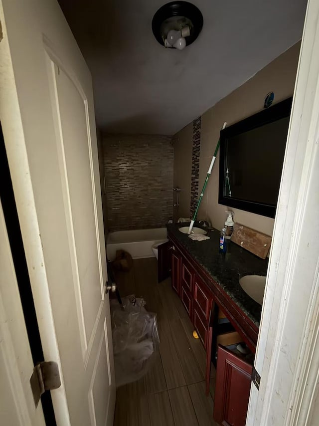788 Dean Dr, Baldwin, NY 11510 - bathroom featuring a tub to relax in, double vanity, and wood finished floors