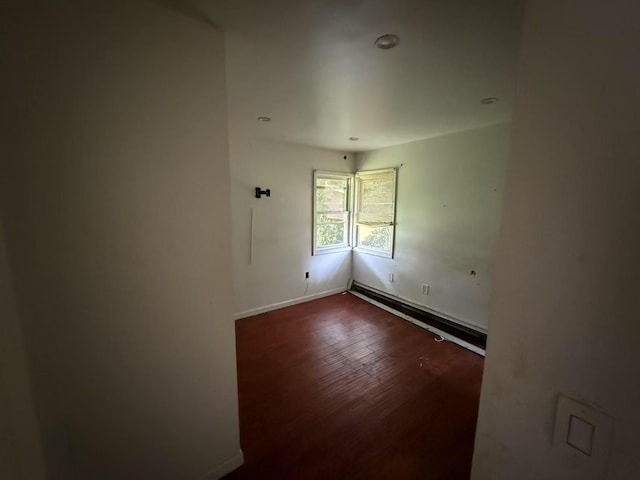 788 Dean Dr, Baldwin, NY 11510 - empty room with dark wood finished floors, a baseboard radiator, and recessed lighting
