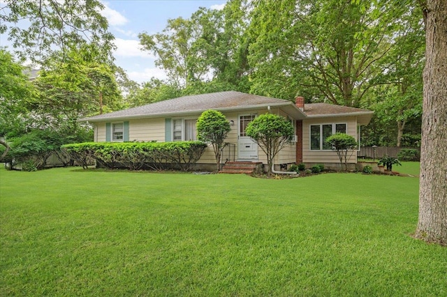 241 Hampton St, East Hampton, NY 11963 - view of front facade with a chimney and a front lawn
