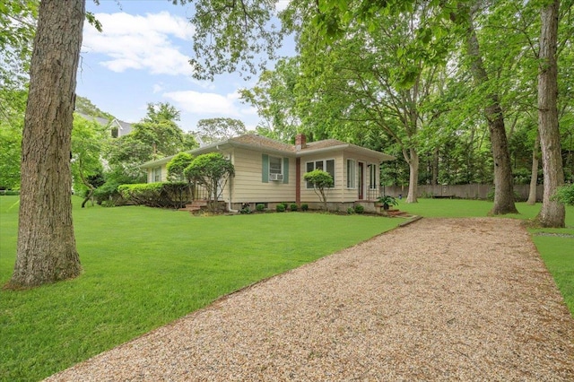 241 Hampton St, East Hampton, NY 11963 - ranch-style house featuring a chimney and a front lawn