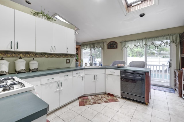 1464 Potter Blvd, Bay Shore, NY 11706 - kitchen with dishwasher, a skylight, white cabinets, light tile patterned flooring, and recessed lighting