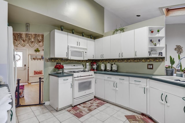 1464 Potter Blvd, Bay Shore, NY 11706 - kitchen with white appliances, dark countertops, open shelves, white cabinets, and light tile patterned flooring