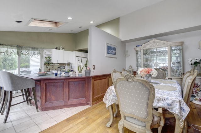 1464 Potter Blvd, Bay Shore, NY 11706 - dining space featuring light tile patterned floors, vaulted ceiling, and recessed lighting