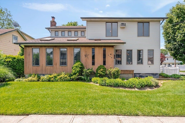 403 S 1st St, Lindenhurst, NY 11757 - view of front facade featuring a front yard, a chimney, and a shingled roof