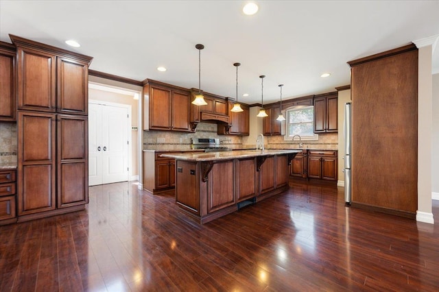403 S 1st St, Lindenhurst, NY 11757 - kitchen featuring stainless steel appliances, a kitchen breakfast bar, an island with sink, ornamental molding, and light stone countertops