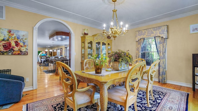 59 Lidge Dr, Farmingville, NY 11738 - dining room with a chandelier, arched walkways, wood finished floors, and crown molding