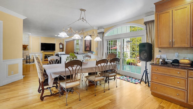 59 Lidge Dr, Farmingville, NY 11738 - dining space with ornamental molding, light wood-style flooring, and wainscoting
