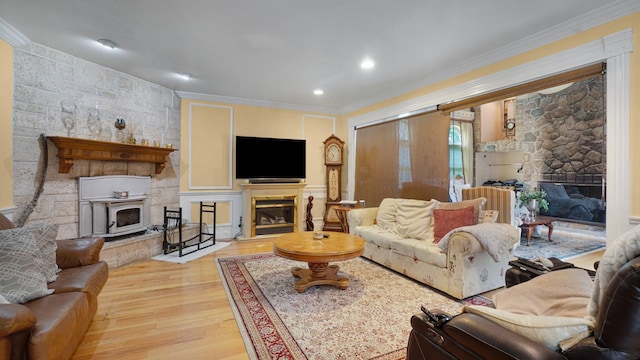 59 Lidge Dr, Farmingville, NY 11738 - living room featuring a glass covered fireplace, wood finished floors, crown molding, and recessed lighting